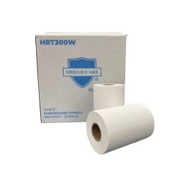 Rolls of white hardwound towels in front of their box.
